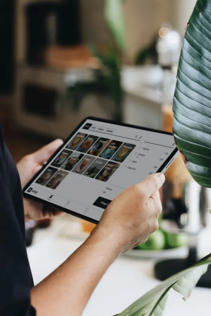 Restaurant owner using custom-built POS system on a tablet